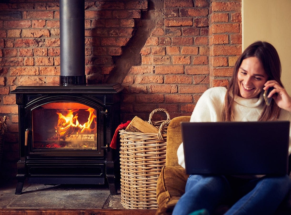 lit woodburner with firewood