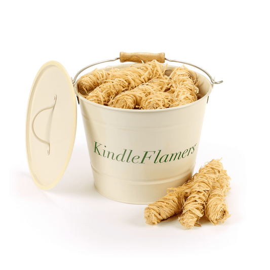 A cream-colored metal bucket with the brand name 'KindleFlamers' printed in green, filled with natural wood wool firelighters