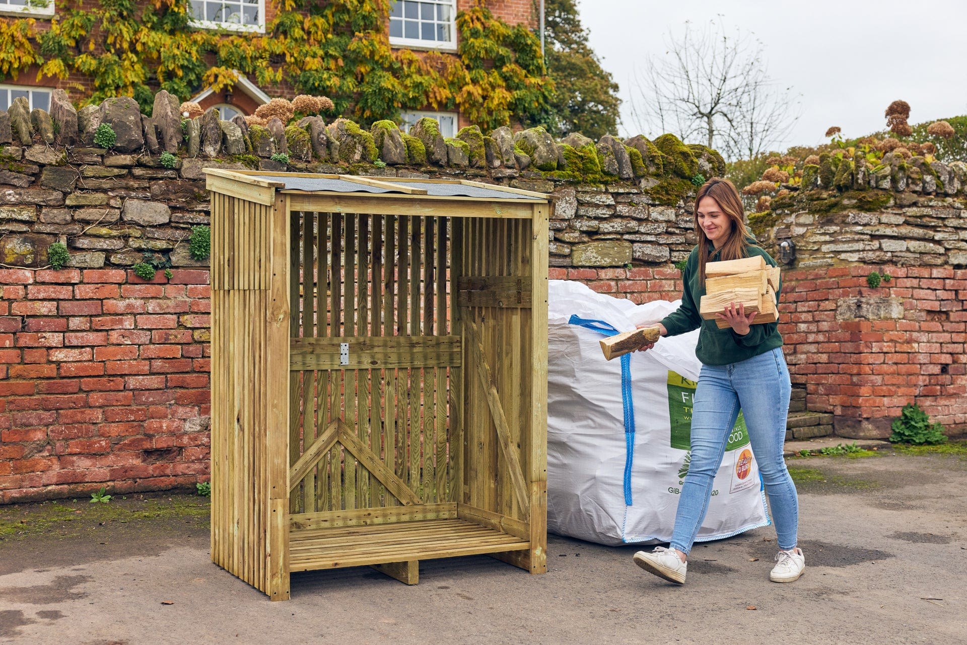 a lady unpacking a bulk bag of firewood to load into her log store