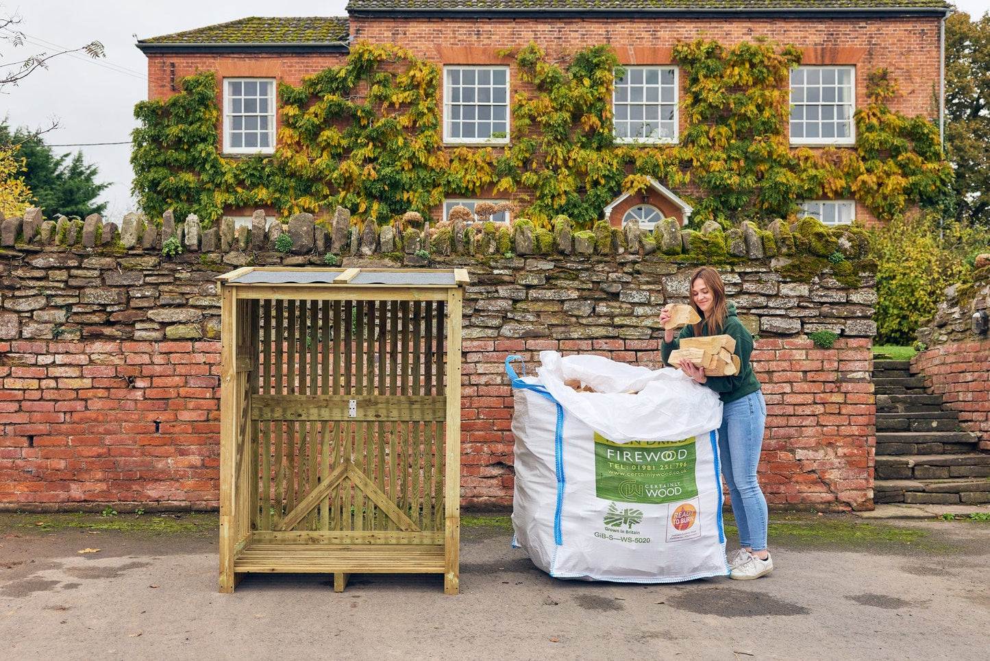 a lady unpacking her bulk bag of firewood ready for her a log store