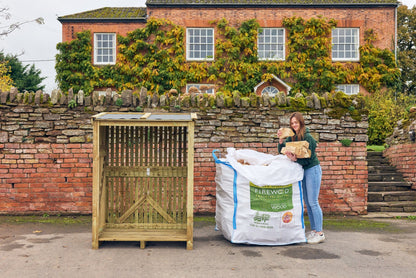 a lady unpacking her bulk bag of firewood ready for her a log store